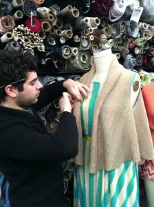 JC cuts, drapes and pins on the dressforms.