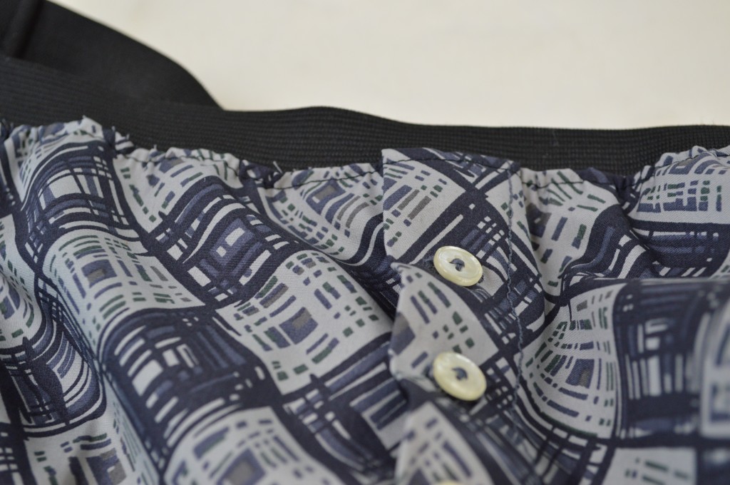 Sew-in Buttons and exposed waistband.