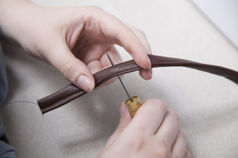 Awl piercing the leather