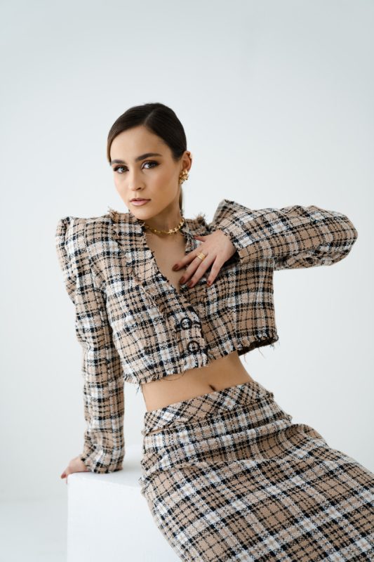 woman wearing a tweed cropped blazer and knee length skirt set