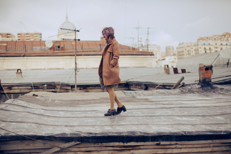 woman wearing a brown knee length coat