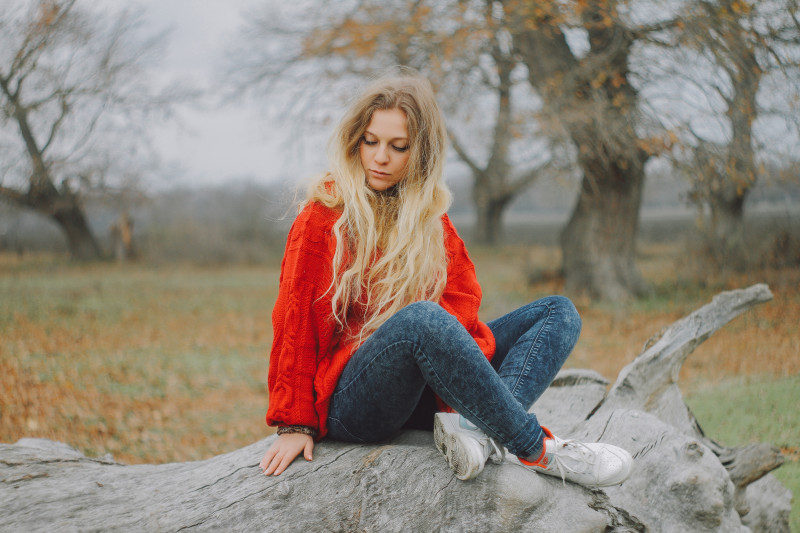 woman sitting down wearing a sweater