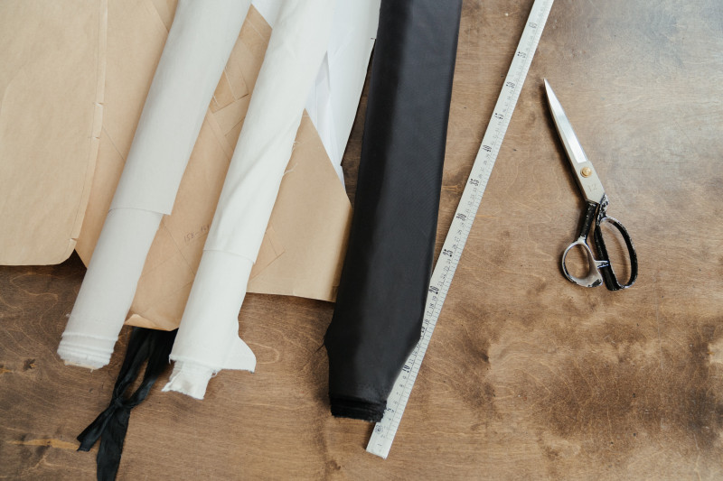 flat lay of fabric rolls and sewing tools