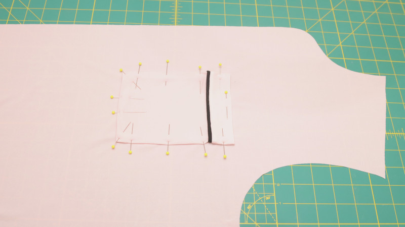 Press the 1/2" seam allowance around all the edges. Sew the pocket onto the front of the shirt by top stitching around the edges, leaving the top open.