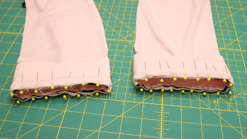 Sew the sleeve cuff to the bottom of the sleeve with piping in between.