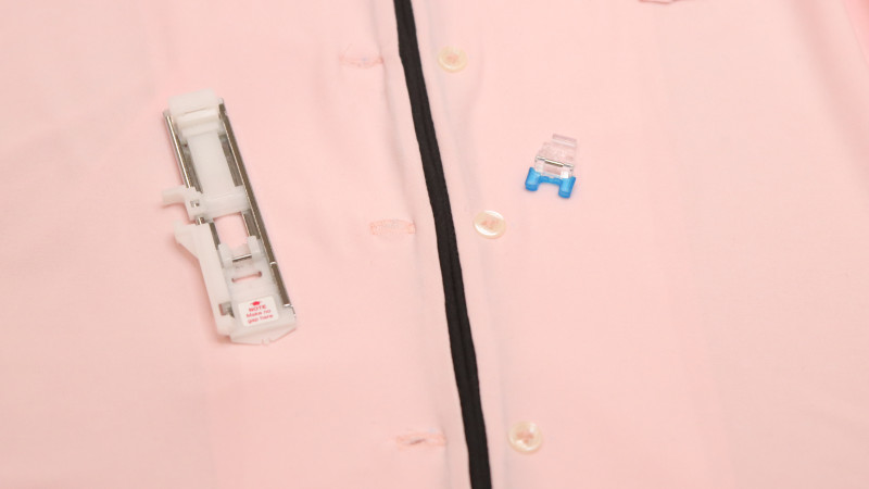 Mark the placement of the buttons on one side and the button holes on the other side. Use a buttonhole foot and a button presser foot to sew the front closure.