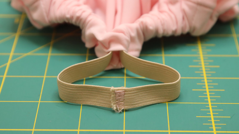Sew the ends of the elastic together with a zig-zag stitch. Close the opening at center back by sewing across to meet the stitch lines.