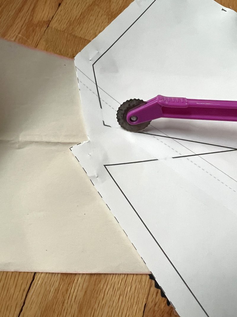 How to mark the darts onto the fabric using tracing paper and a tracing wheel.