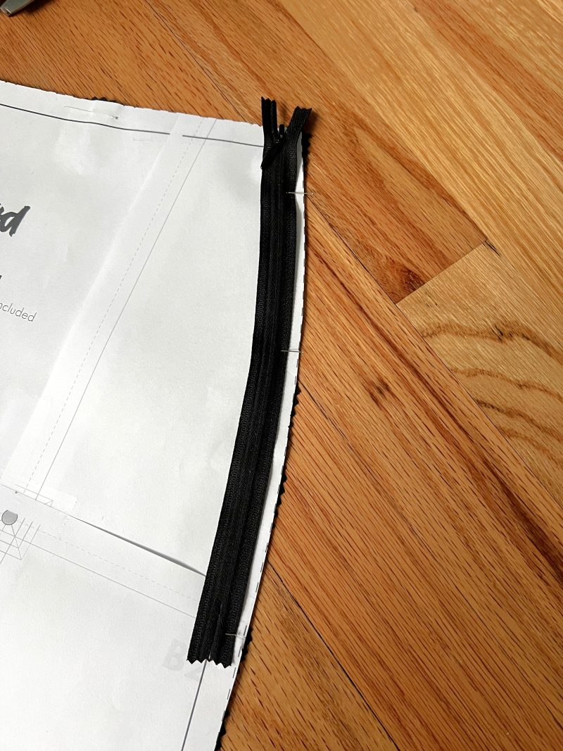 How to place the zipper over the pattern to determine where to place a notch.