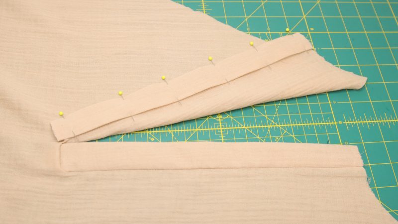 How to fold the front placket over to the wrong side of the dress