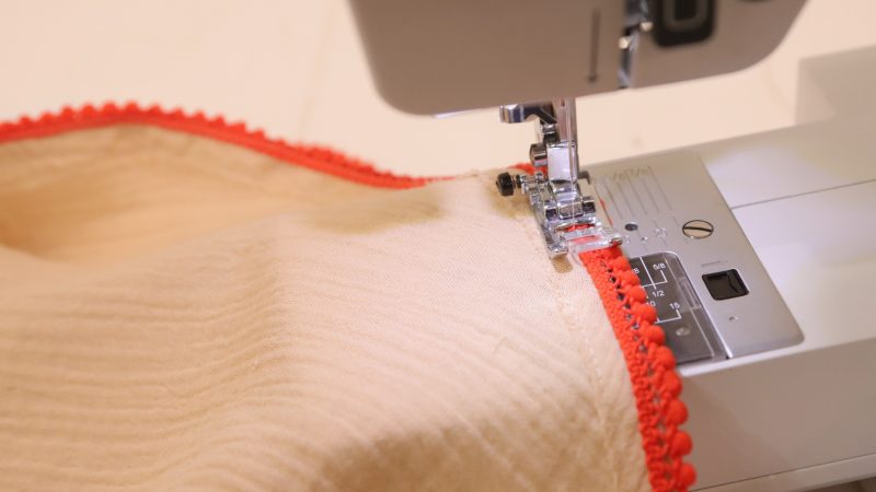How to sew the miniature pom pom trim to the edge of the sleeves