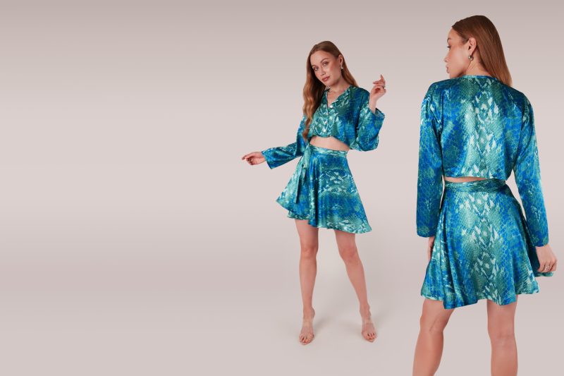 Front and back view of model wearing python printed silk set