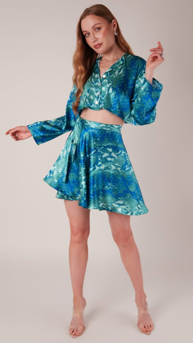 Front view of model posing wearing matching set button up shirt and wrap skirt made from python printed silk charmeuse | MDF441 - Mood Fabrics Sewciety Blog