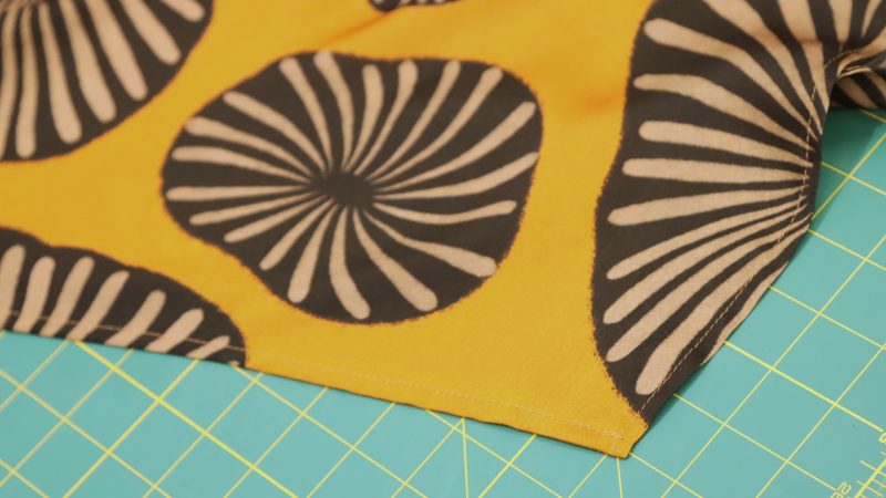 How to sew a 1/4" double-folded hem around the bottom of the dress