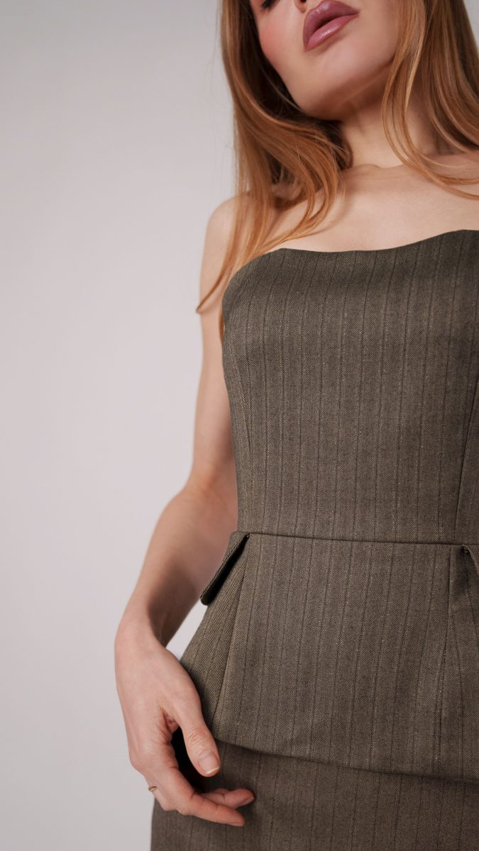 Close-up of Brown and Chinchilla Metallic Herringbone Striped Polyester Suiting fabric styled as The Ela Peplum Top & Ava Mini Skirt, free sewing pattern from the Mood Fabrics Sewciety blog.