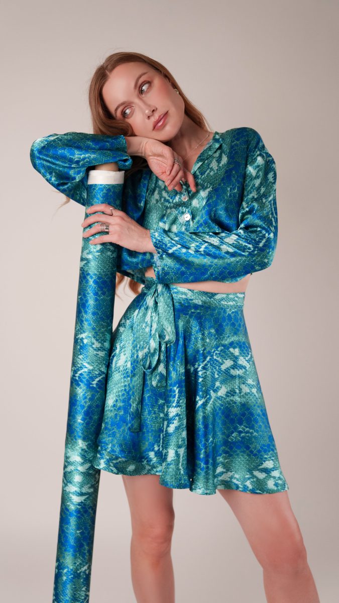 Model wearing The Pirouette Luxe Set relaxed-fit button-down top in Italian royal and jade python silk charmeuse, styled with matching skirt, Mood Fabrics Sewicety Blog.