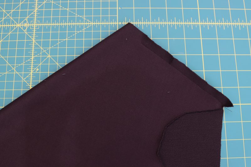 How-To-Pin-Sew-Seam-Along-Notches-Leaving-Opening-Dark Chocolate Stretch Polyester Crepe Knit--Mood-Fabrics Pin and sew seam perpendicular to the notches, but leave a 1 inch opening at the folded edge.