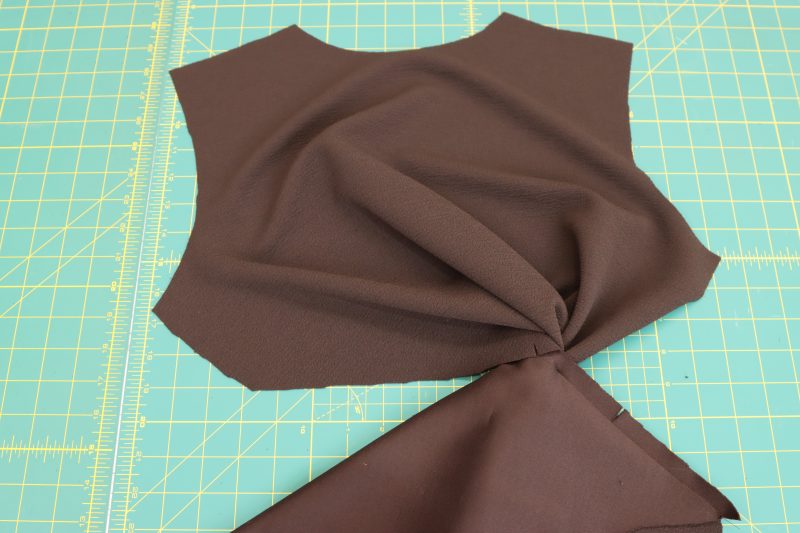 How-To-Insert-Long-Tail-From-Upper-Front-Twist-Into-Lower-Front-Twist-Dark Chocolate Stretch Polyester Crepe Knit--Mood-Fabrics Insert long tail from upper front twist into the opening on the front lower twist.