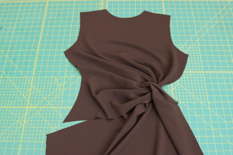 How-To-Sew-Seam-Perpendicular-To-Notches-Of-Front-Upper-Twist-Dark Chocolate Stretch Polyester Crepe Knit--Mood-Fabrics Sew the seam perpendicular to the notches on the front upper twist, leaving a small hole along the folded edge.