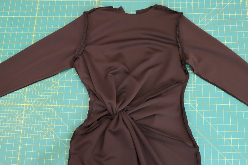 How-To-Sew-Continuous-Stitch-From-Wrist-to-Hem-Dark Chocolate Stretch Polyester Crepe Knit--Mood-Fabrics Sew a continuous stitch from wrist, to armpit, to bottom hem to attach the front and back of the dress together at the side seams.