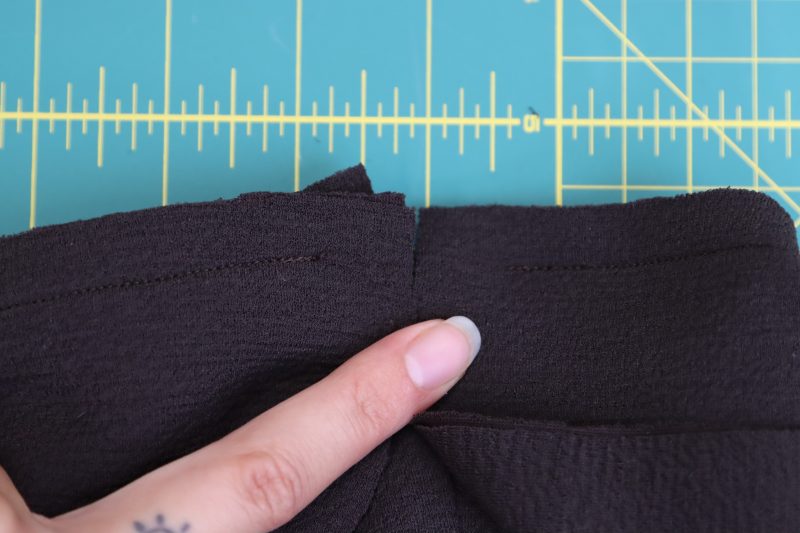 How-To-Leave-One-Inch-Gap-at-Ends-of-Seams-Dark Chocolate Stretch Polyester Crepe Knit--Mood-Fabrics Leave 1 inch between the beginning and end of the stitch and the center back opening of the dress to enclose the zipper.