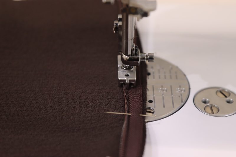 How To Sew Zipper-Along-Pins-With-Invisible-Zipper-Foot - Invisible Zipper 24" by YKK - 917 Dark Chocolate - Nob Hill Draped Midi Dress - MDF458 - Mood Fabrics Sewciety Blog Sew the first side of the zipper along where the pins were placed using an invisible zipper foot.