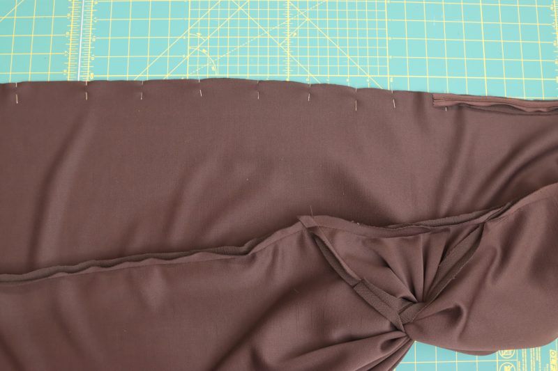 How To Pin-Sew Center-Back-Seam-Closed - Dark Chocolate Stretch Polyester Crepe Knit - Nob Hill Draped Midi Dress - MDF458 - Mood Fabrics Sewciety Blog Pin the center back seam closed from the bottom hem to ½ inch above the zipper stopper.