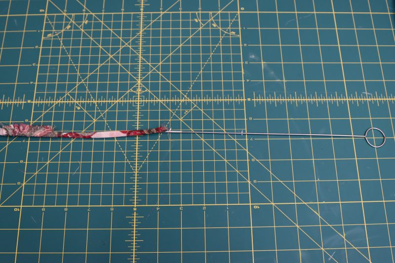 How To Turn Cord Tunnel Right Sides Out Using Tube Turner - Italian-Polyester-Georgette - Baratti Blouson Dress - MDF457 - Mood Fabrics Sewciety Blog Turn tunnel inside out using tube turner to create the ties.