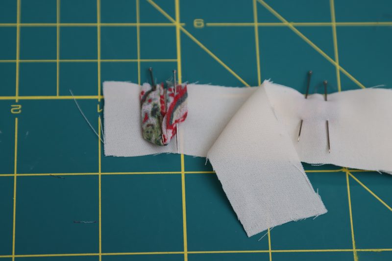 How To Pin Loops To Lining Fabric - Italian-Polyester-Georgette - Baratti Blouson Dress - MDF457 - Mood Fabrics Sewciety Blog Pin looped fabric strips between the lining fabric pieces.