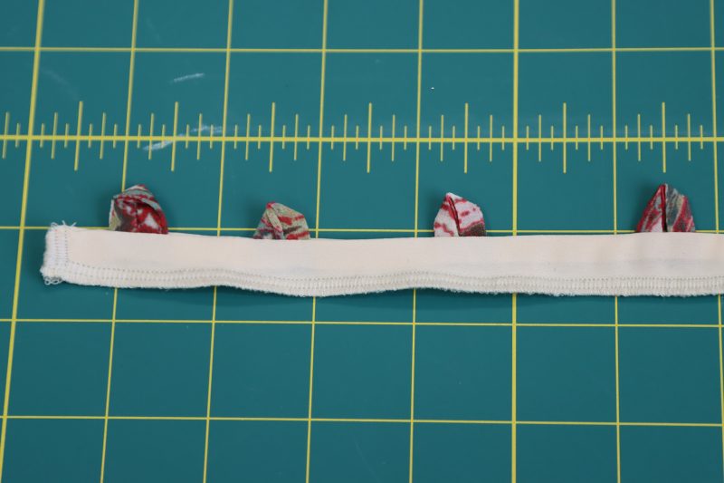 How To Serge Raw Edge Loop Placket - Polyester-Double-Georgette-Mimosa-Collection - Baratti Blouson Dress - MDF457 - Mood Fabrics Sewciety Blog Serge the raw edges of the button loop placket.