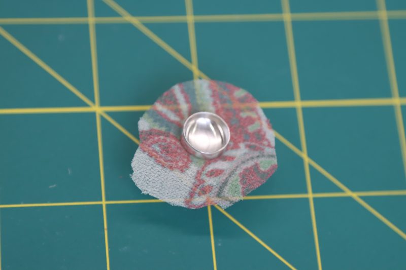 How To Place Fabric Under Button - Italian-Polyester-Georgette - Baratti Blouson Dress - MDF457 - Mood Fabrics Sewciety Blog Place fabric over the rubber holder.
