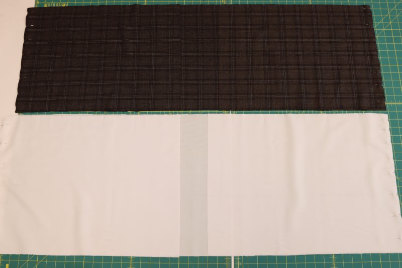 How To Pin Side Seams Of Shell and Inner Skirt - Super 130s Wool Twill Suiting Made in Italy Charcoal Gray Navy Plaid Deadstock - Mood Fabrics - Oxford Pleated Skirt and Tie Free Sewing Pattern Tutorial - MDF460 - Mood Fabrics Sewciety Blog - Pin and sew the side seams together for both the lining and shell pieces.