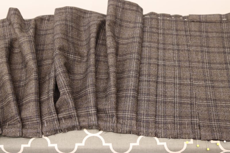 How To Iron Shell Pleats - Super 130s Wool Twill Suiting Made in Italy Charcoal Gray Navy Plaid Deadstock - Mood Fabrics - Oxford Pleated Skirt and Tie Free Sewing Pattern Tutorial - MDF460 - Mood Fabrics Sewciety Blog - Begin ironing down the pleats on the shell layer.