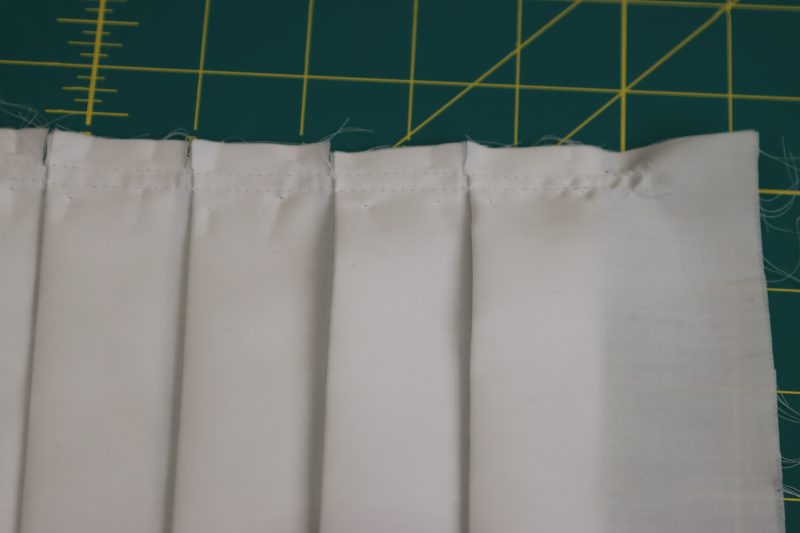 How To Sew Inner Skirt Pleats - Egyptian Cotton Shirting Optic White Giza Collection - Mood Fabrics - Oxford Pleated Skirt and Tie Free Sewing Pattern Tutorial - MDF460 - Mood Fabrics Sewciety Blog - Sew the pleats down on the inner skirt piece.