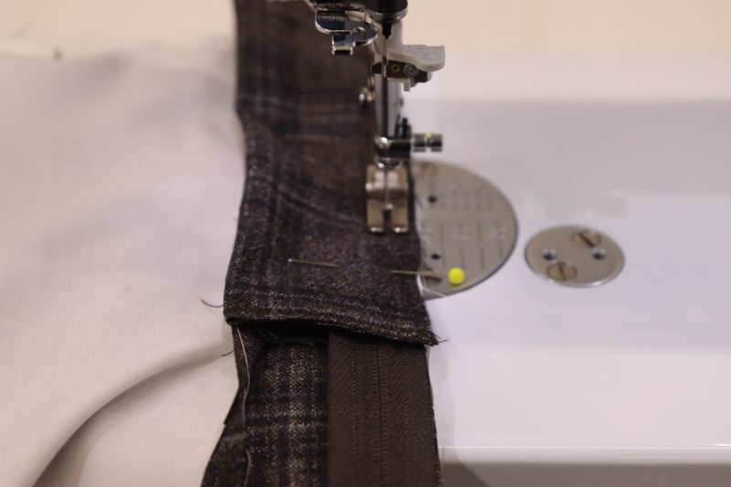 How To Sew Fly Shield To Zipper and Center Seam - Regular Zipper 9 Inch YKK 916 After Dark - Mood Fabrics - Oxford Pleated Skirt and Tie Free Sewing Pattern Tutorial - MDF460 - Mood Fabrics Sewciety Blog - Sew the fly shield to the zipper and the front right side of the skirt.