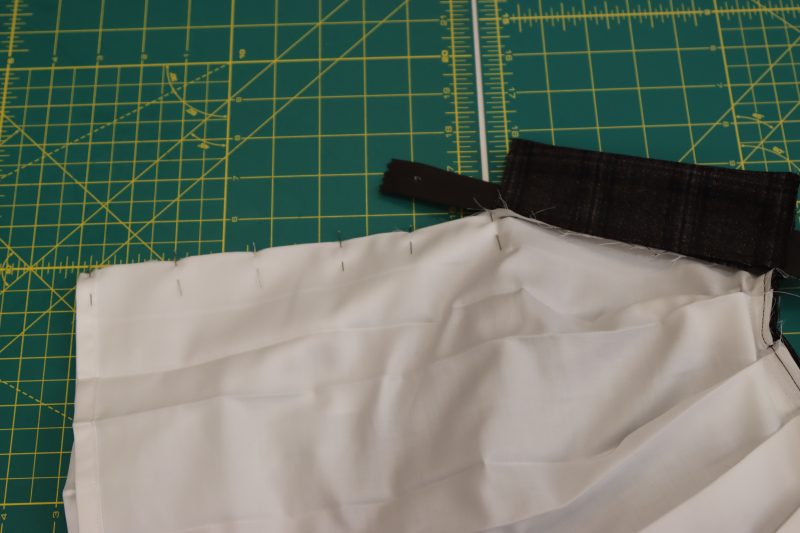 How To Pin Front Center Seam Of Skirt Together - Egyptian Cotton Shirting Optic White Giza Collection - Mood Fabrics - Oxford Pleated Skirt and Tie Free Sewing Pattern Tutorial - MDF460 - Mood Fabrics Sewciety Blog - Pin the front center seam of the skirt inner skirt right sides together.