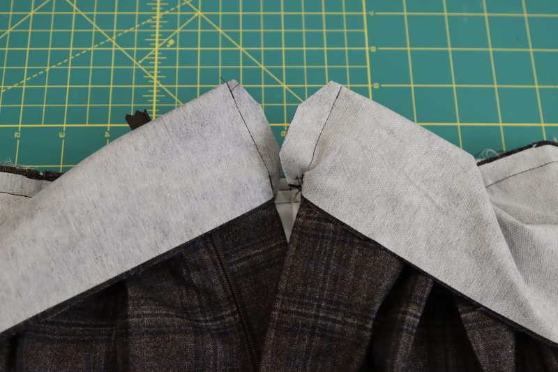 How To Pin Sew Ends Of Waistband Shut - Super 130s Wool Twill Suiting Made in Italy Charcoal Gray Navy Plaid Deadstock - Mood Fabrics - Oxford Pleated Skirt and Tie Free Sewing Pattern Tutorial - MDF460 - Mood Fabrics Sewciety Blog - Pin and sew the ends of the waistband shut, right sides together.