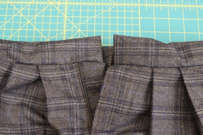 How To Turn Waistband Right Sides Out - Super 130s Wool Twill Suiting Made in Italy Charcoal Gray Navy Plaid Deadstock - Mood Fabrics - Oxford Pleated Skirt and Tie Free Sewing Pattern Tutorial - MDF460 - Mood Fabrics Sewciety Blog - Flip the waistband right sides out.