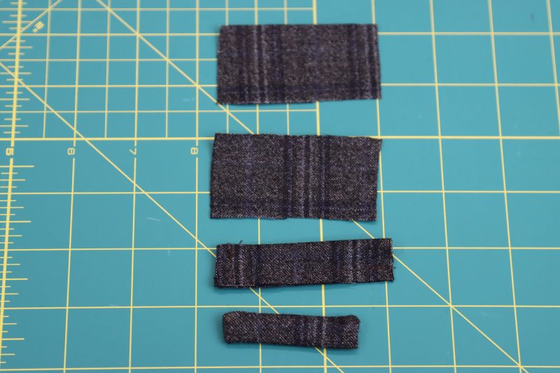 How To Sew Belt Loops Shut - Super 130s Wool Twill Suiting Made in Italy Charcoal Gray Navy Plaid Deadstock - Mood Fabrics - Oxford Pleated Skirt and Tie Free Sewing Pattern Tutorial - MDF460 - Mood Fabrics Sewciety Blog - Sew the belt loops shut, leaving one of the short ends shut to flip them inside out.