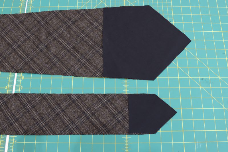 How To Pin Lining Pieces To Tie Ends - Super 130s Wool Twill Suiting Made in Italy Charcoal Gray Navy Plaid Deadstock - Mood Fabrics - Oxford Pleated Skirt and Tie Free Sewing Pattern Tutorial - MDF460 - Mood Fabrics Sewciety Blog - Pin the lining pieces to the ends of the tie pieces, right sides together.