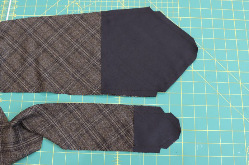 .How To Clip Corners Of Tie Pieces - Super 130s Wool Twill Suiting Made in Italy Charcoal Gray Navy Plaid Deadstock - Mood Fabrics - Oxford Pleated Skirt and Tie Free Sewing Pattern Tutorial - MDF460 - Mood Fabrics Sewciety Blog - Clip the corners of each end of the tie.