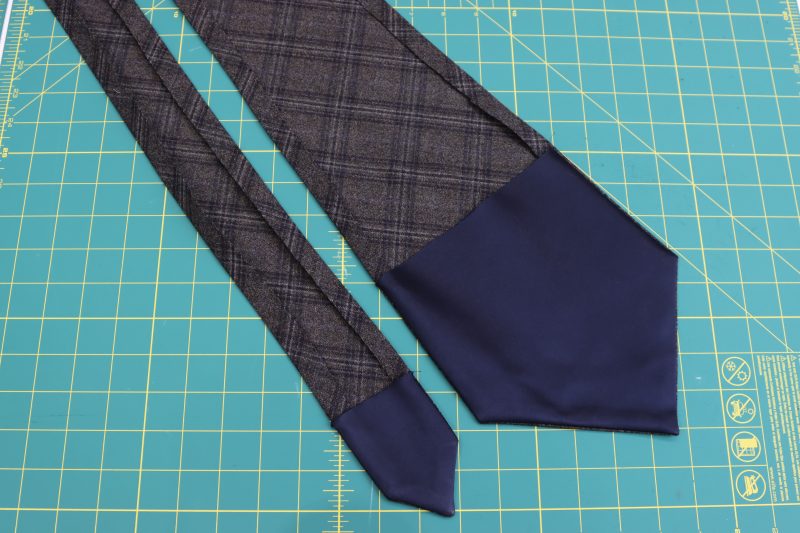 How To Iron Half Inch Hem Along Length Of Tie - Super 130s Wool Twill Suiting Made in Italy Charcoal Gray Navy Plaid Deadstock - Mood Fabrics - Oxford Pleated Skirt and Tie Free Sewing Pattern Tutorial - MDF460 - Mood Fabrics Sewciety Blog - Turn the tie right sides out and iron the ½ inch hem.
