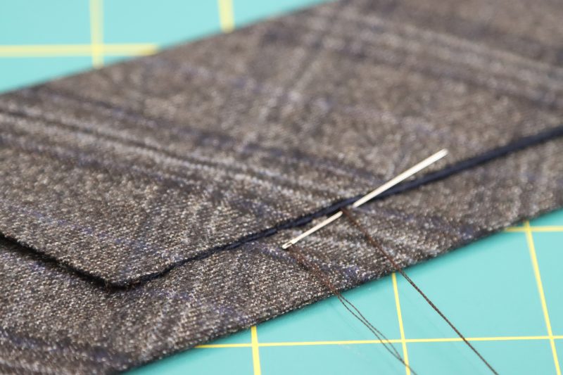 How To Sew Ladder Stitch by Hand - Super 130s Wool Twill Suiting Made in Italy Charcoal Gray Navy Plaid Deadstock - Mood Fabrics - Oxford Pleated Skirt and Tie Free Sewing Pattern Tutorial - MDF460 - Mood Fabrics Sewciety Blog - Turn the tie right sides out and iron the ½ inch hem.