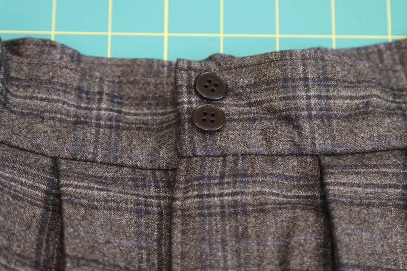 How To Mark Positions Of Buttons and Buttonholes - 24L Chocolate Horn 4 Hole Button - Mood Fabrics - Oxford Pleated Skirt and Tie Free Sewing Pattern Tutorial - MDF460 - Mood Fabrics Sewciety Blog - Mark the positions of the buttons and buttonholes.