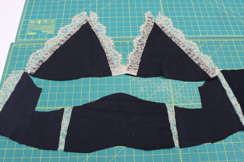 How To Layout Pattern Pieces - Washed Silk Charmeuse 19mm Black - Mood Fabrics - Odette Nightgown Free Sewing Pattern Tutorial - MDF462 - Mood Fabrics Sewciety Blog - Lay out pattern pieces including silk panels, lace trim, and lace cutouts.
