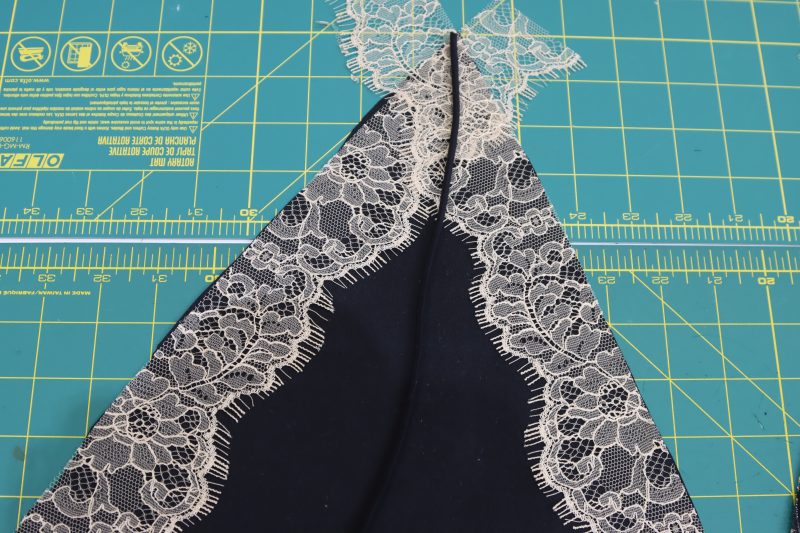 How To Sandwich Lace Trim And Elastic Cord - Peach Floral Scalloped Re Embroidered Lace with Eyelash Fringe - Mood Fabrics - Odette Nightgown Free Sewing Pattern Tutorial - MDF462 - Mood Fabrics Sewciety Blog - Sandwich lace trim and elastic cord between the two silk bra cups.
