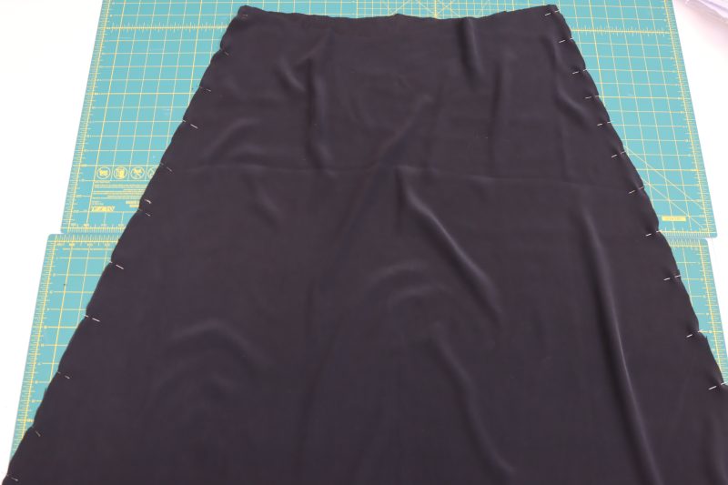 How To Pin Sew Side Seams Of Underskirt - Washed Silk Charmeuse 19mm Black - Mood Fabrics - Odette Nightgown Free Sewing Pattern Tutorial - MDF462 - Mood Fabrics Sewciety Blog - Pin and sew the side seams of the underskirt.