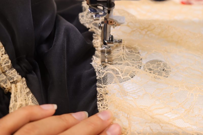 How To Sew Over Underbust Seam - Washed Silk Charmeuse 19mm Black - Mood Fabrics - Odette Nightgown Free Sewing Pattern Tutorial - MDF462 - Mood Fabrics Sewciety Blog - Sew directly over the seam that connects the bra cups to the underbust to secure the ruffle in place.