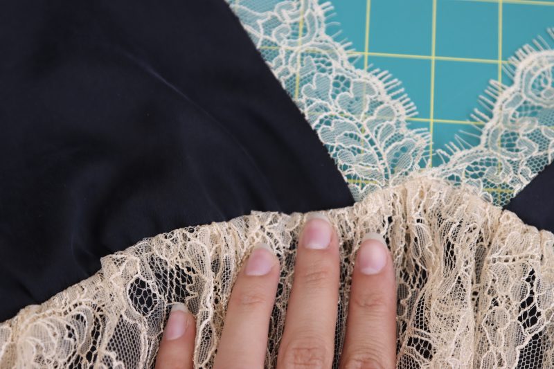 How To Flip Underbust Ruffle - Peach Floral Scalloped Re Embroidered Lace with Eyelash Fringe - Mood Fabrics - Odette Nightgown Free Sewing Pattern Tutorial - MDF462 - Mood Fabrics Sewciety Blog - Flip the lace over to hide the gathered edge and seam.