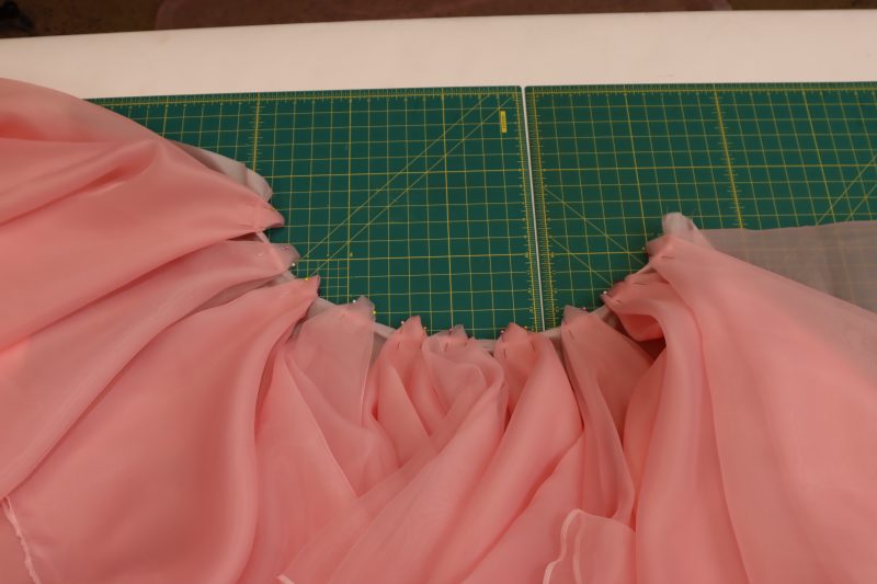 How To Pin Sew Underskirt To Lining - Organza - Mood Fabrics - Glinda Gown Free Sewing Pattern Tutorial - MDF463 - Mood Fabrics Sewciety Blog - Pin and sew the underskirt ruffles to the waist of the skirt lining.